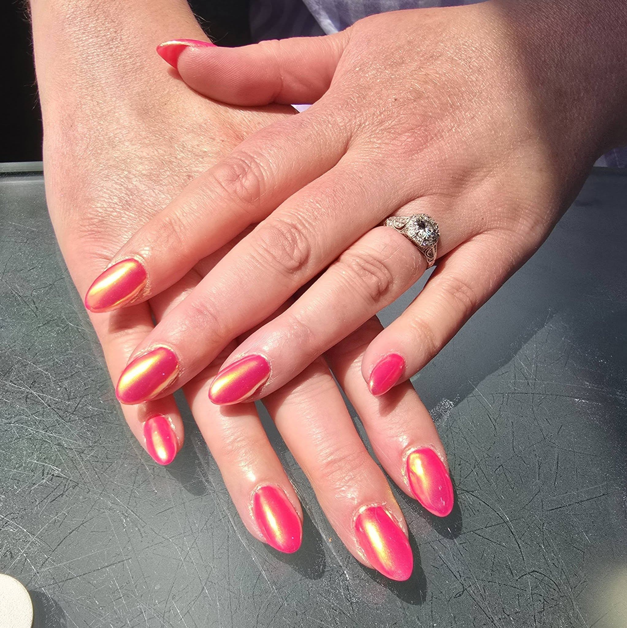Silver nail design with pink crystal